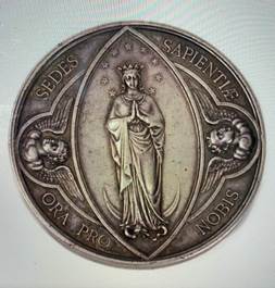 A silver coin with a picture of a person

Description automatically generated