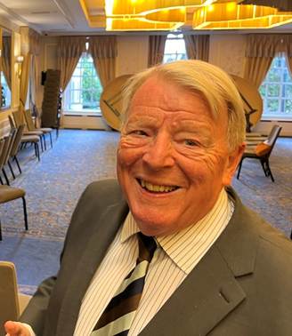 Two men in suits and ties

Description automatically generated